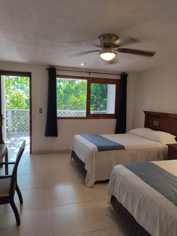 Postel nebo postele na pokoji v ubytování Hotel Puerta Chichen