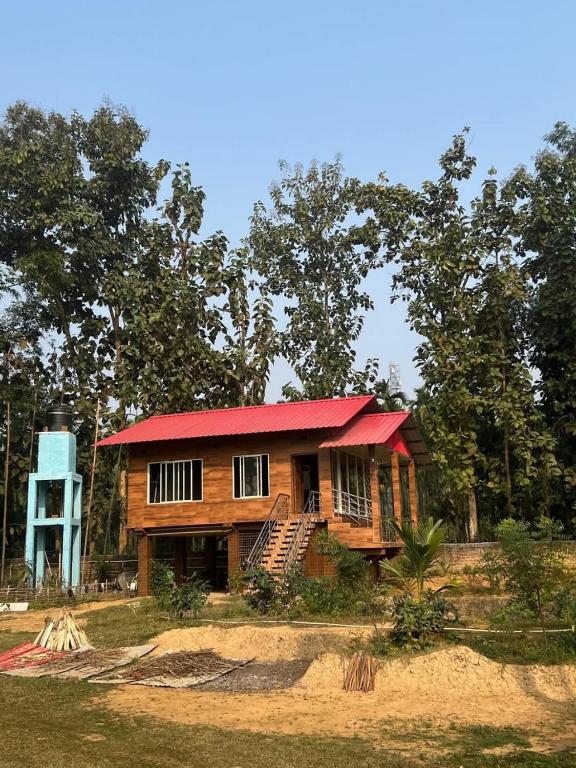 a small wooden house with a red roof at Digaru Air House in Digru