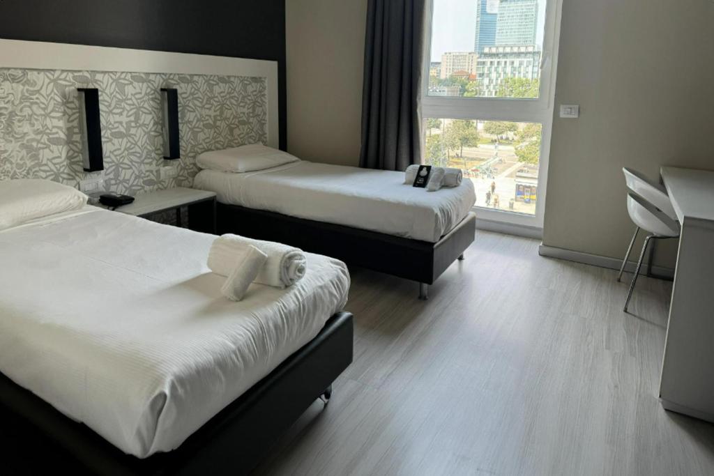 Postel nebo postele na pokoji v ubytování B&B Hotel Milano Aosta