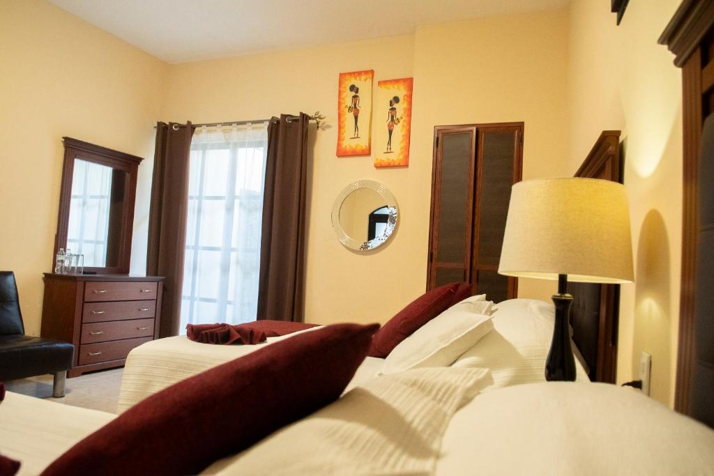 Postel nebo postele na pokoji v ubytování Hotel Villa Bernal