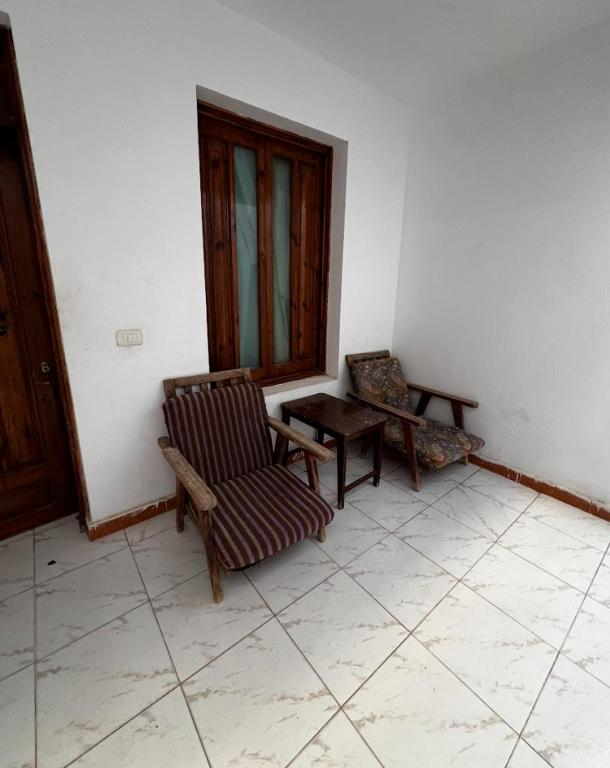 a room with two chairs and a table and a window at Octopus Hotel in Dahab