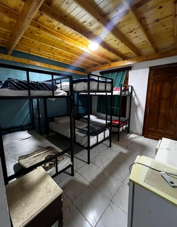 a dorm room with three bunk beds in it at Octopus Hotel in Dahab
