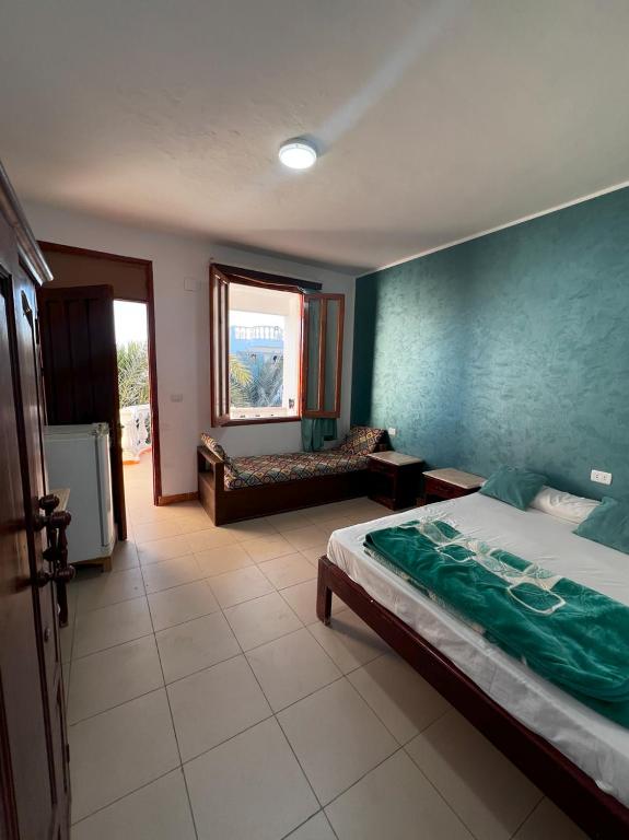 a bedroom with a bed and a couch in it at Octopus Hotel in Dahab