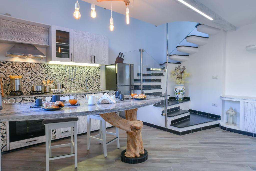 a kitchen with a large counter in a room at Domus Minerva in Massa Lubrense