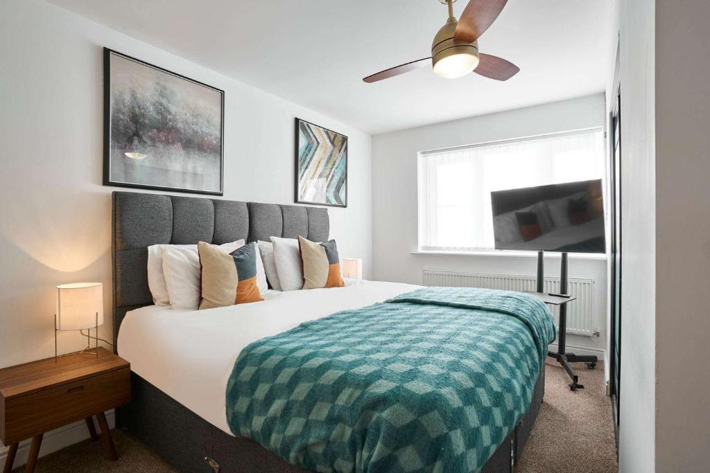 a bedroom with a large bed and a ceiling fan at Host & Stay - Cherry Blossom House in Launceston