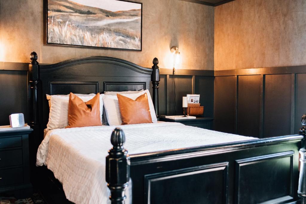 a bedroom with a large bed with orange pillows at Moody Blues Studio Perfect For Work Or Romance in Memphis
