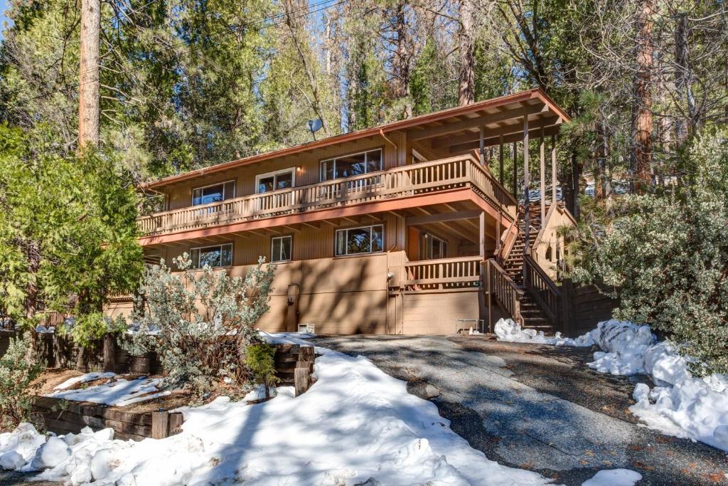 a log home in the woods in the snow at Bird's Eye View in Yosemite West