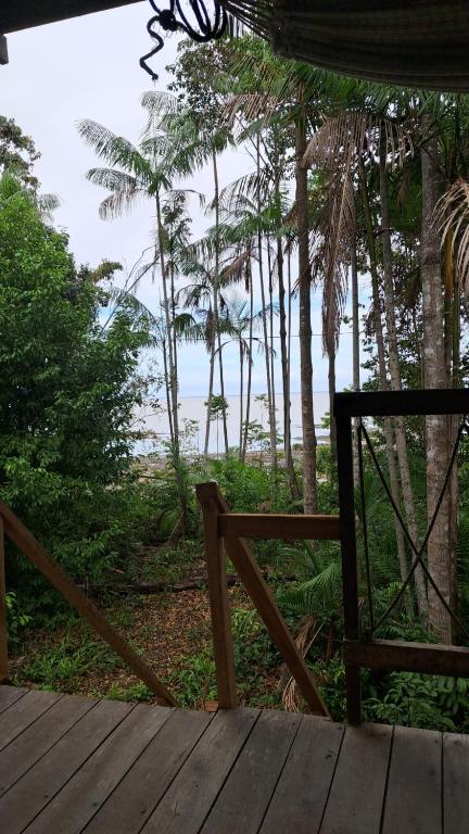 a wooden porch with a view of the ocean at casa de descano in Belém