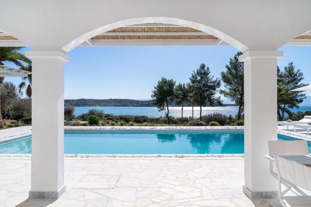 a view of the pool from the patio of a villa at Villa Seascape, Beachfront Living in the Greek Riviera Porto Heli in Porto Heli