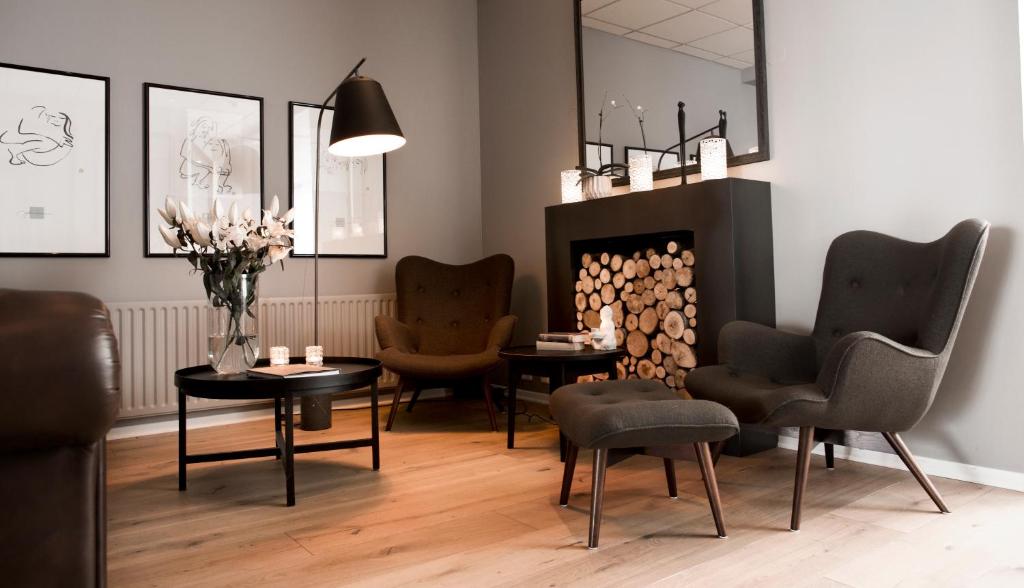a waiting room with chairs and a fireplace at 22 Hill Hotel in Reykjavík