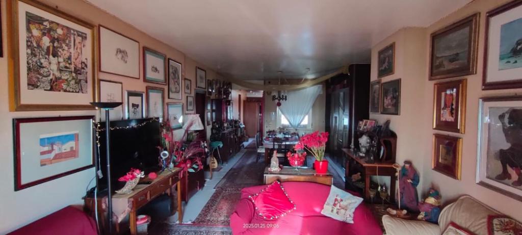 a living room with a large pink bed in a room at MAMY PENTHOUSE in Palermo