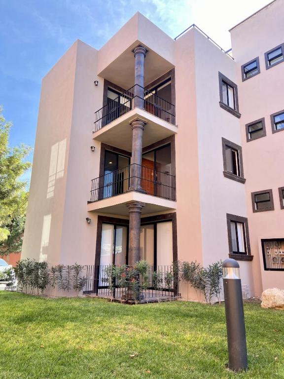 an apartment building with balconies and columns at EL Colibrí in San Miguel de Allende
