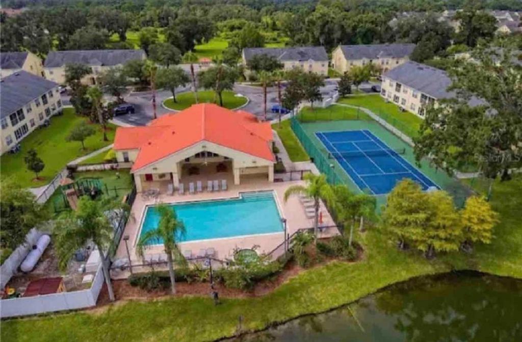 an aerial view of a house with a tennis court at October Deal Only 97 Dollars 3-Bedroom Family Condo, Pool & More - Just 12 Mins to Disney! Cortile in Kissimmee