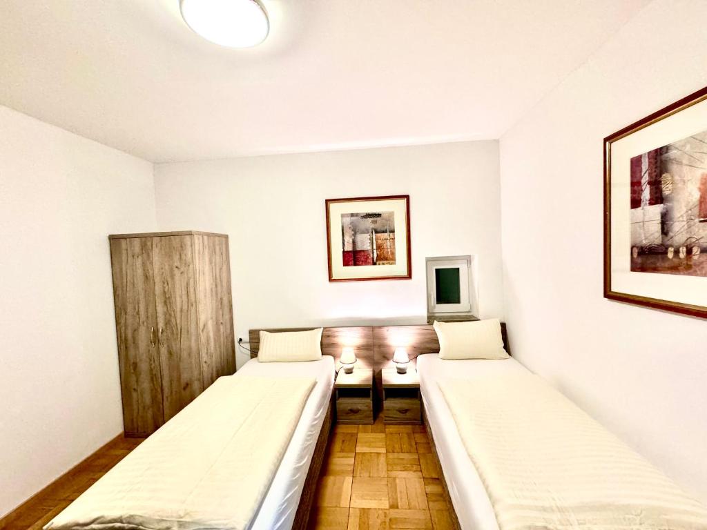 a room with two beds and a tv at Hotel Soad in Salach