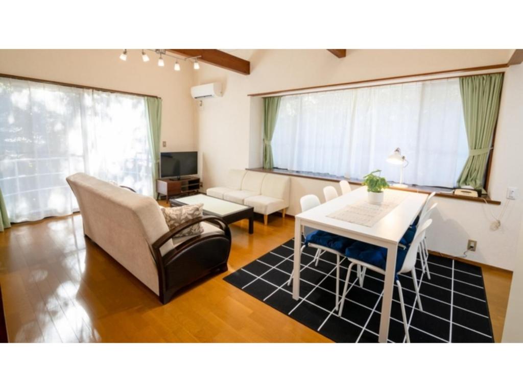a living room with a couch and a table at Le Nessa Akazawa - Vacation STAY 16387v in Futo