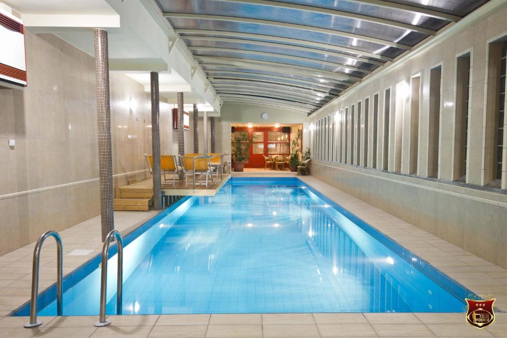 a large swimming pool in a hotel room at Toldi Fogadó in Tokaj