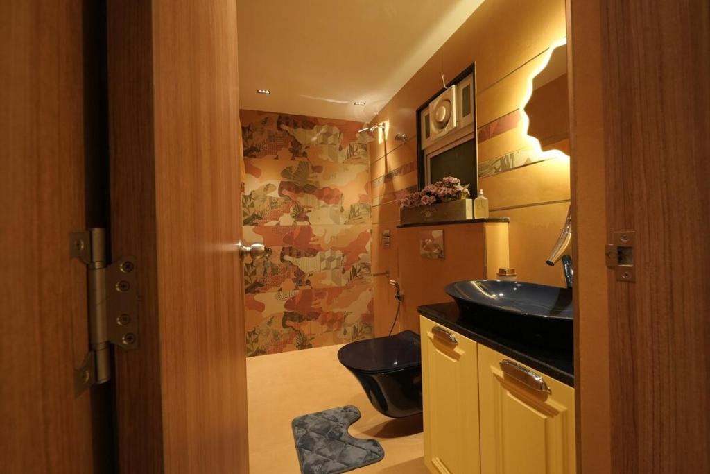 a bathroom with a sink and a toilet in it at Cozy 3 BHK fully furnished apartment in Cochin in Kakkanad