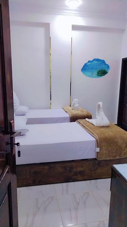 Postel nebo postele na pokoji v ubytování Sama Stars Hotel