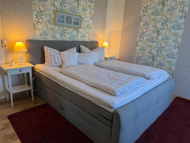 a bedroom with a large bed with two pillows at Haus Sonnenschein in Zingst in Zingst