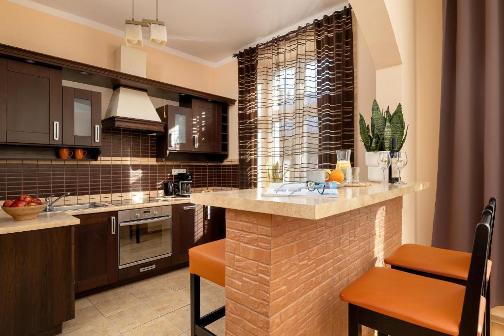 a kitchen with a island in the middle at Caffe latte apartment in Kraków