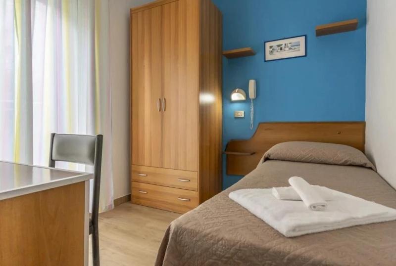 Postel nebo postele na pokoji v ubytování Hotel REX
