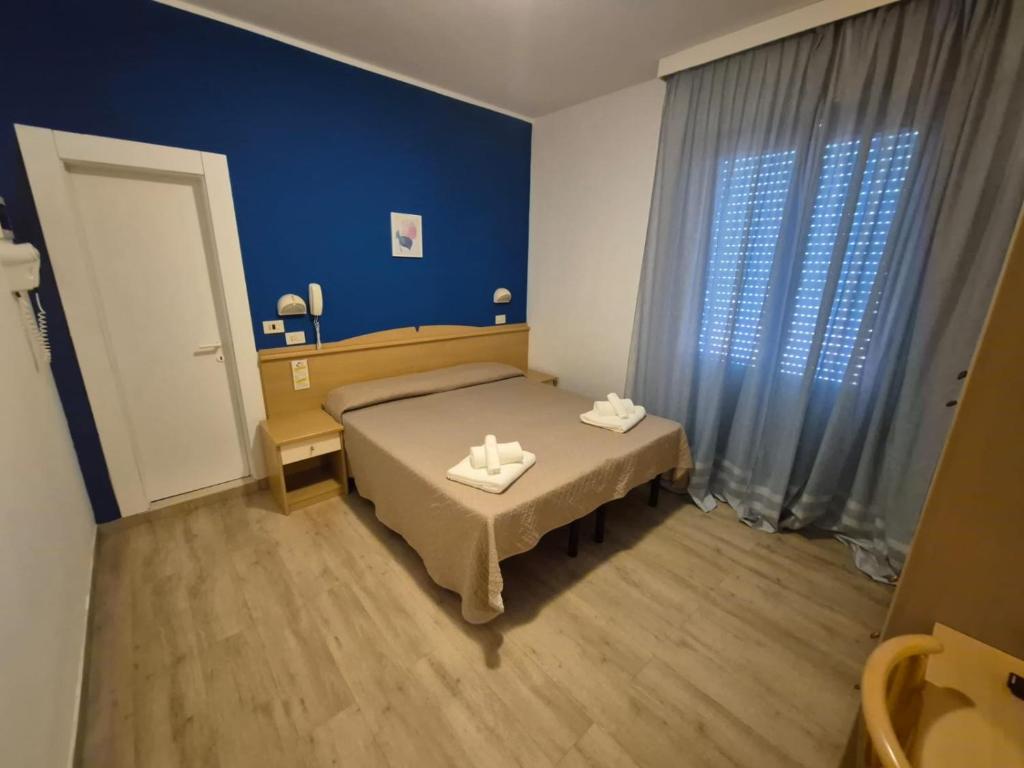 Postel nebo postele na pokoji v ubytování Hotel REX