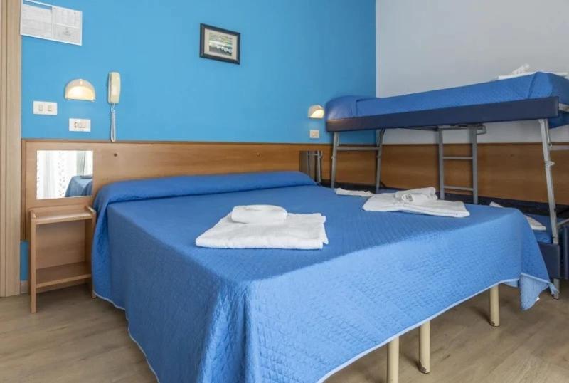 Postel nebo postele na pokoji v ubytování Hotel REX