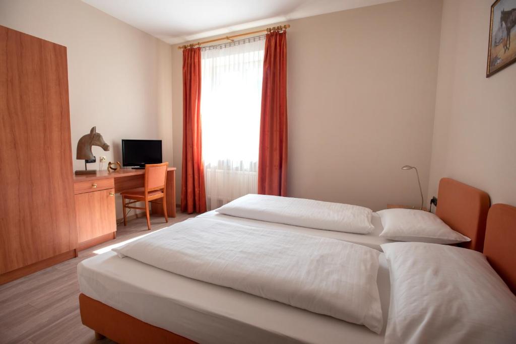 Postel nebo postele na pokoji v ubytování Albergo Cavallino s'Rössl