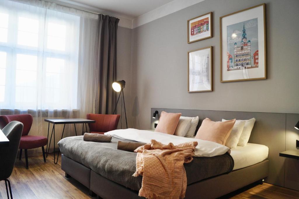 a bedroom with a large bed in a room at Aparthouse Woźna 11 Old Town in Poznań