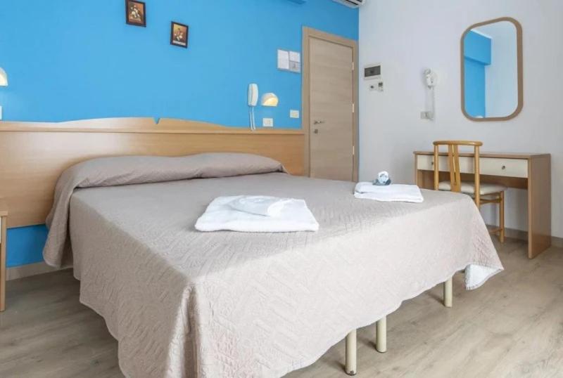Postel nebo postele na pokoji v ubytování Hotel REX