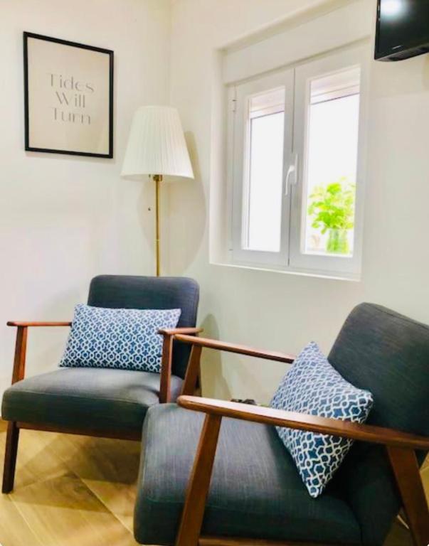 a living room with a chair and a lamp at Entre Muralhas - Cozy Apartment Elvas I in Elvas