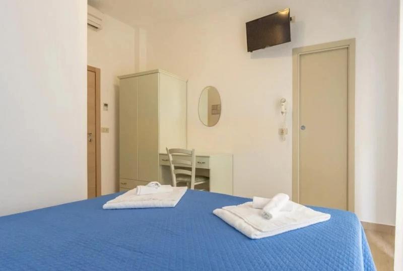 Postel nebo postele na pokoji v ubytování Hotel REX