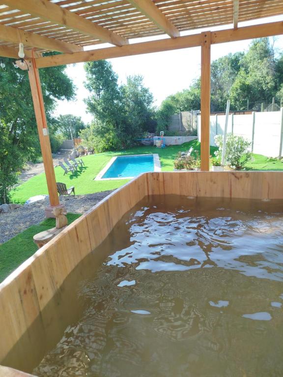 a large pool of water in a wooden tank at Refugio el Amparo de Paine in El Majuelo
