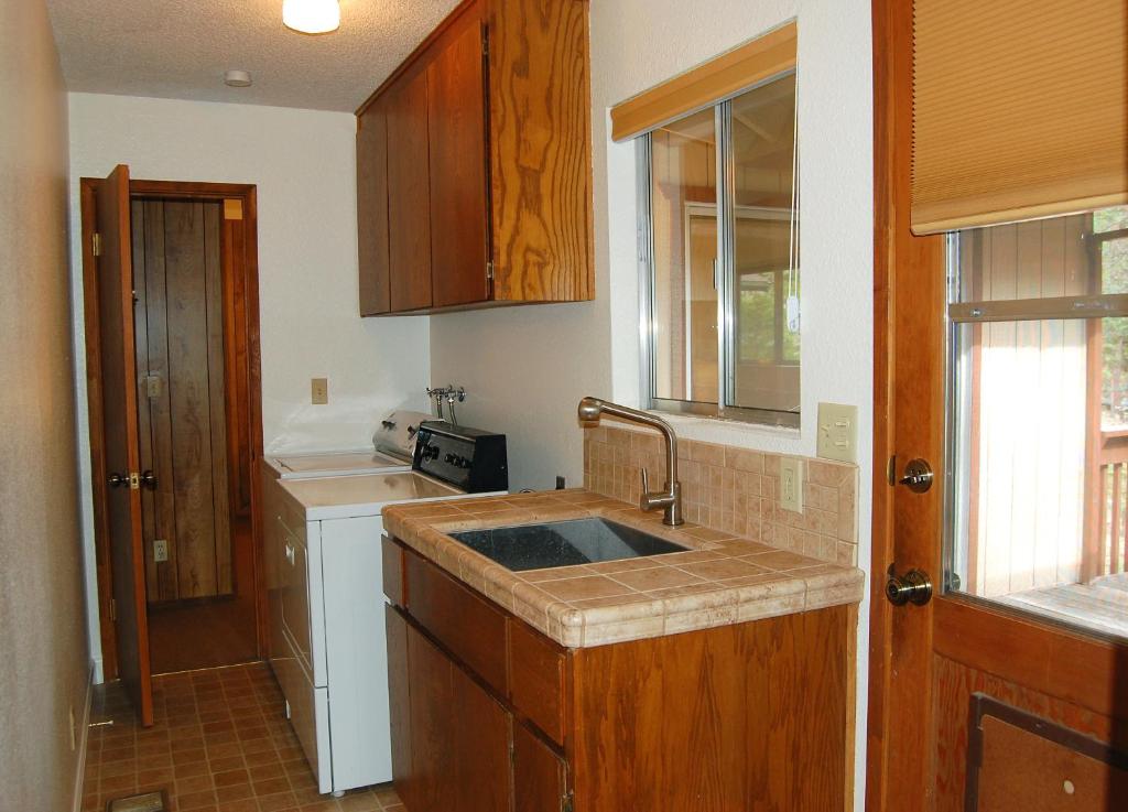 a kitchen with a sink and a counter top at Mountain Retreat in Wawona