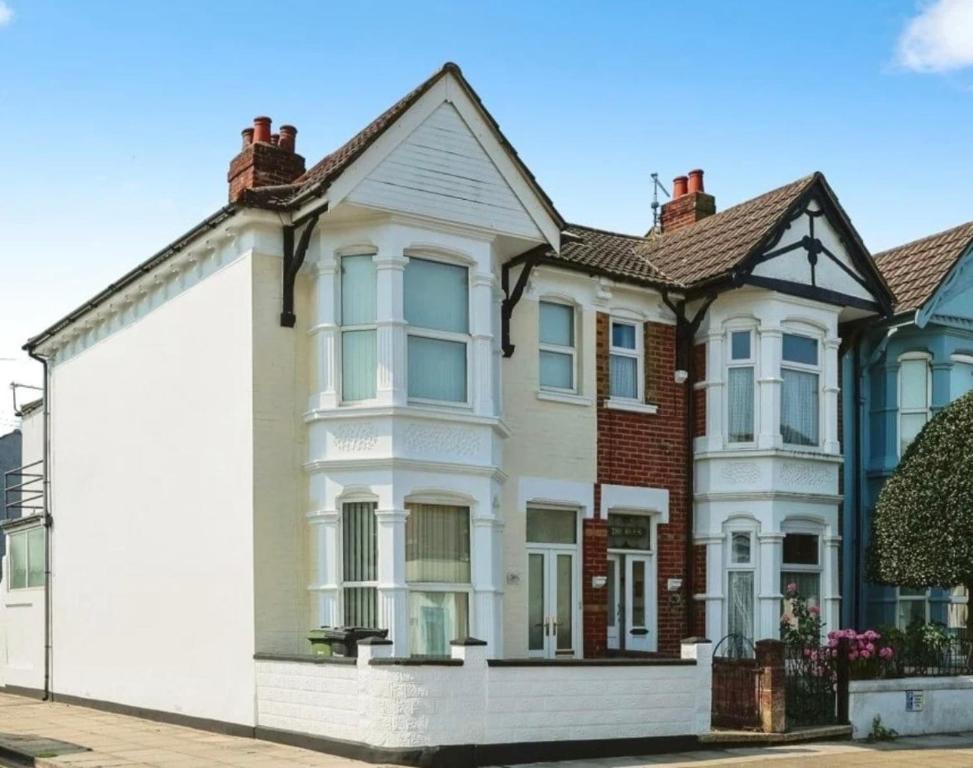 a white house with a red brick at Charming city home free parking in Portsmouth