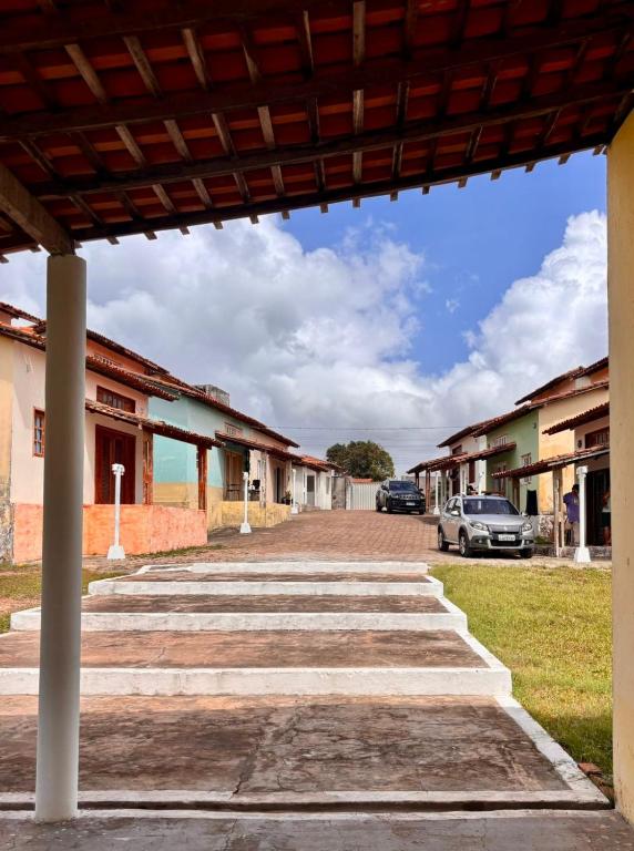 a row of buildings with a car parked on the street at JGM chalés in Barreirinhas