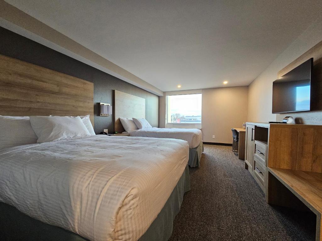 Postel nebo postele na pokoji v ubytování Vittoria Hotel & Suites