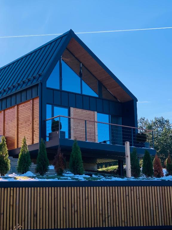 a house with a gambrel roof at Pine Chalet Vodice in Vodice