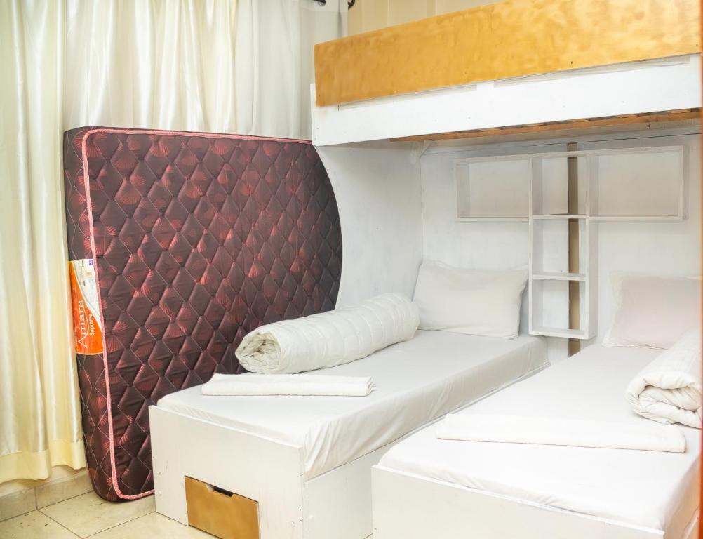 a bunk bed in a room with two beds at Luxury Two Bedroom Master & Suite Apartment in Nairobi
