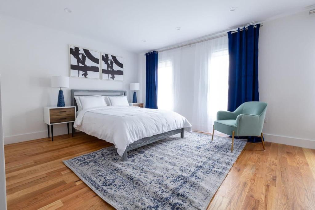 a bedroom with a bed and a blue chair at 323-2 Spacious 2BR Williamsburg in Brooklyn