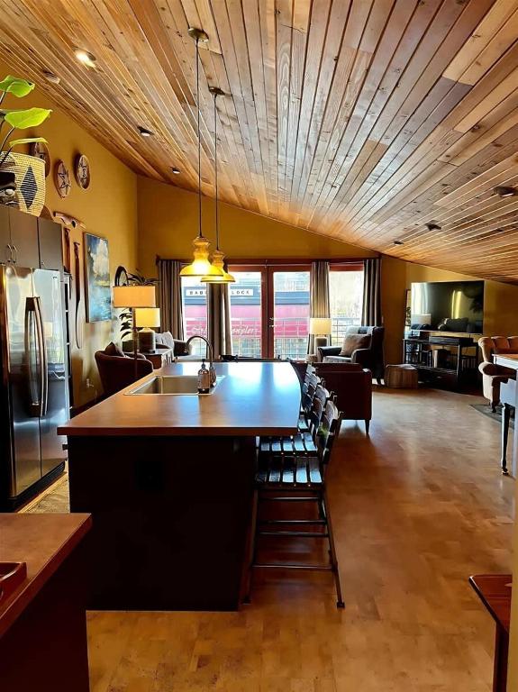 a kitchen with a large island in a living room at Sqc Downtown Retreat in Sequim