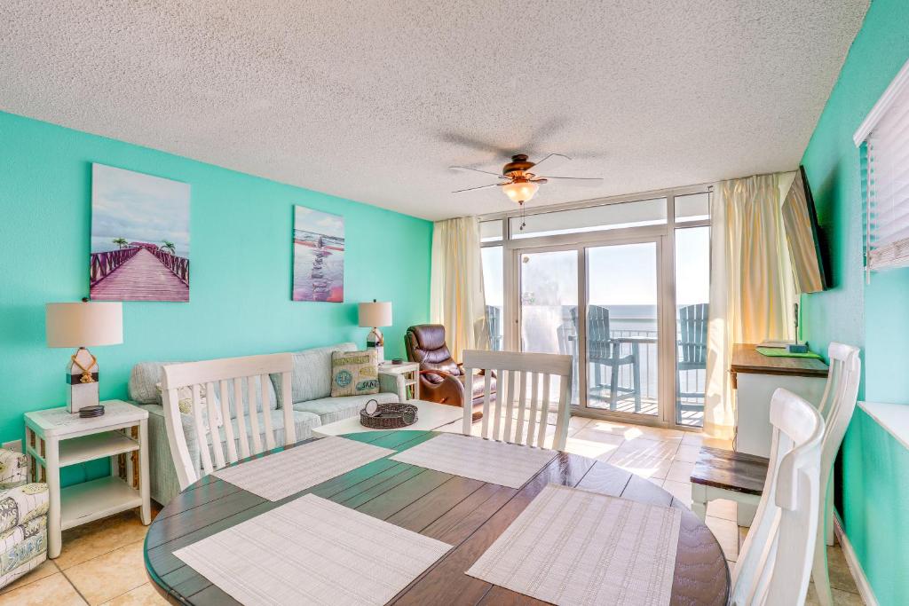a living room with a table and a dining room at Walk to SkyWheel Oceanfront Myrtle Beach Condo! in Myrtle Beach