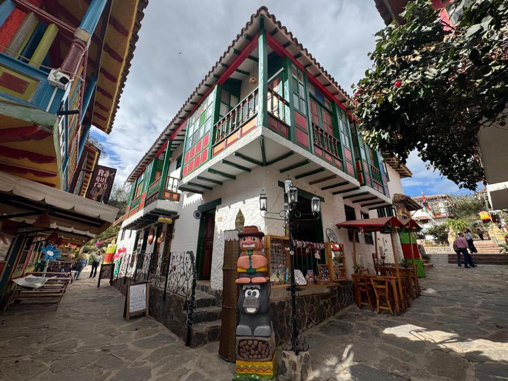 a building with a statue in front of it at La Puerta - Pueblito Boyacense in Duitama