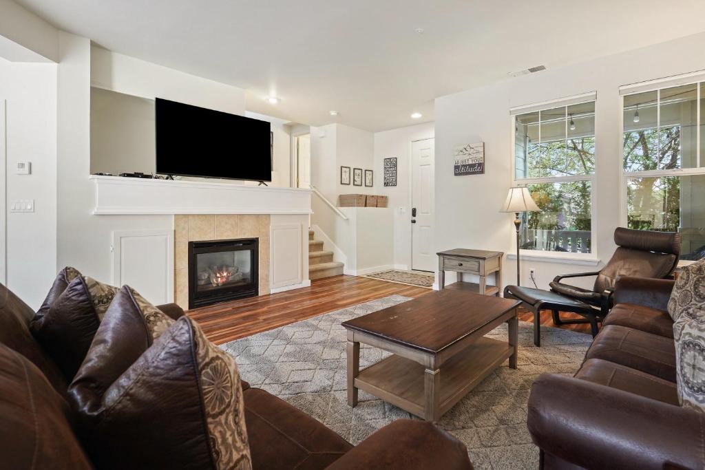 a living room with a couch and a fireplace at Old Mill Magic in Bend