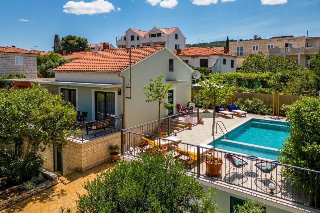an image of a house with a swimming pool at Family friendly house with a swimming pool Supetar, Brac - 23813 in Supetar