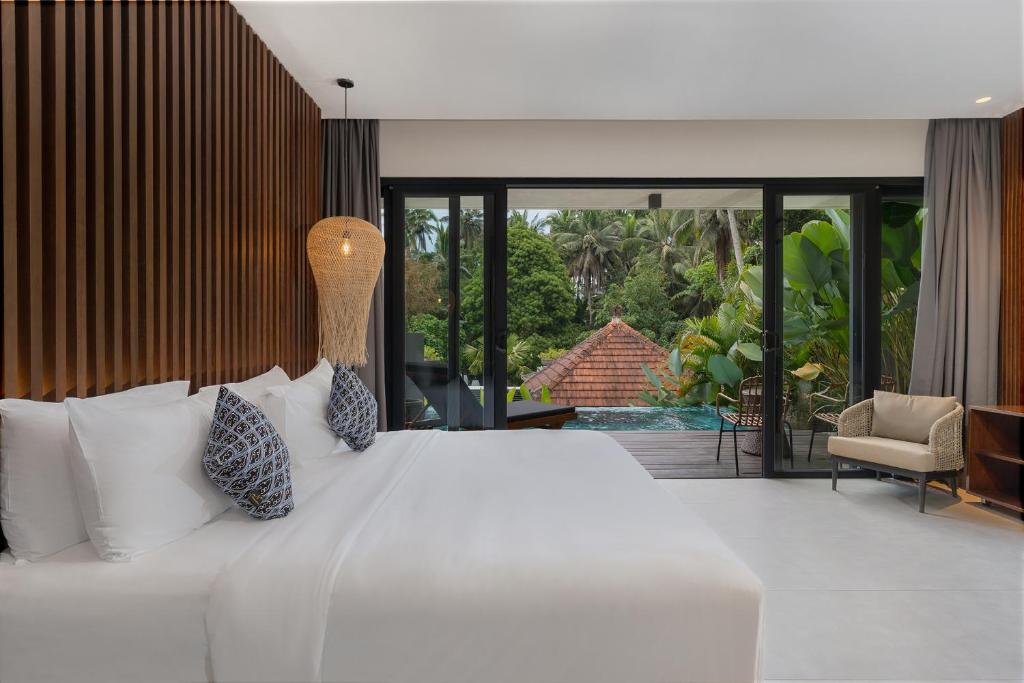 Postel nebo postele na pokoji v ubytování The Ning Resort Ubud