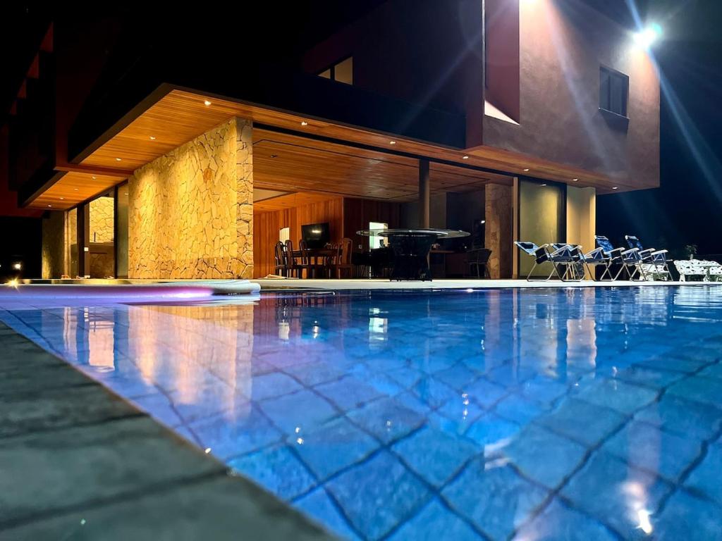 a swimming pool in a building at night at Solar da madame in Morro de São Paulo