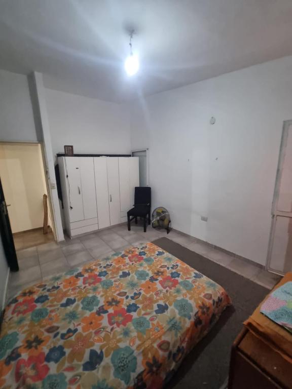 a bedroom with a large bed in a room at Casa amplia in Villa Constitución