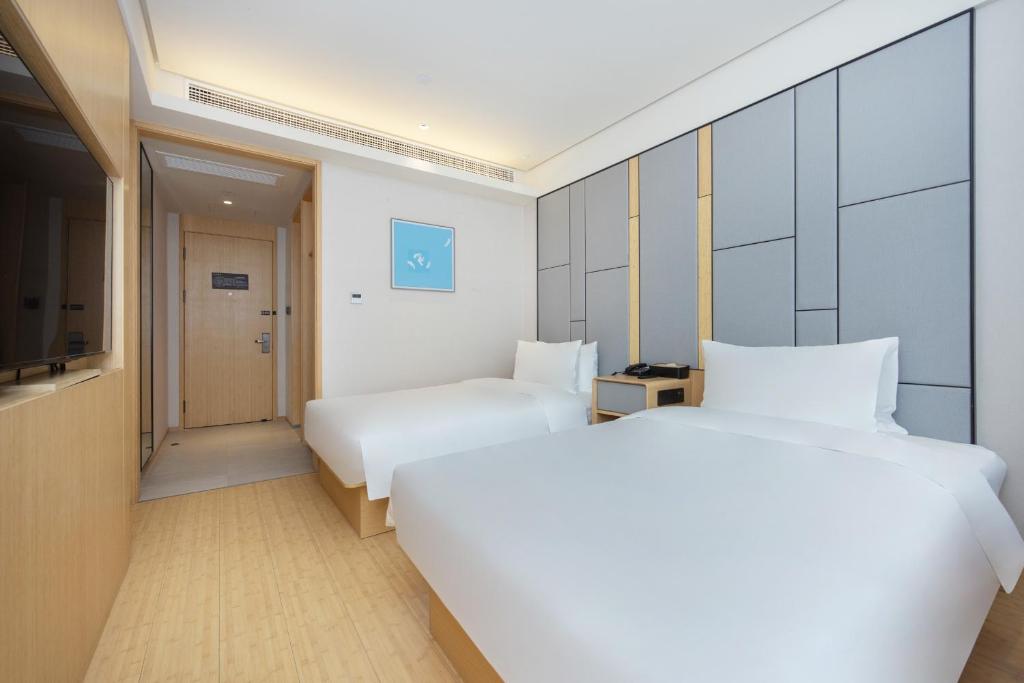 Postel nebo postele na pokoji v ubytování Quanji shanghai Hongqiao Gubei No 1 hotel
