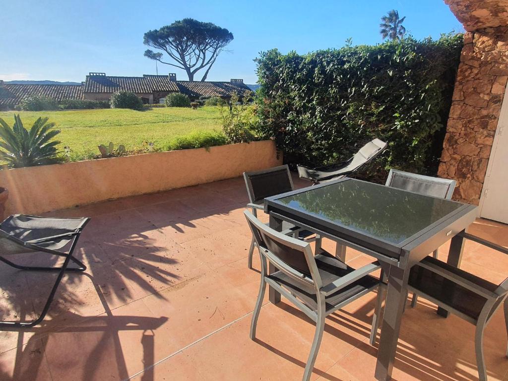 une table et des chaises assises sur une terrasse dans l'établissement Appartement 3 pièces climatisé avec terrasse et piscine privée à Sainte-Maxime - FR-1-780-33, à Sainte-Maxime